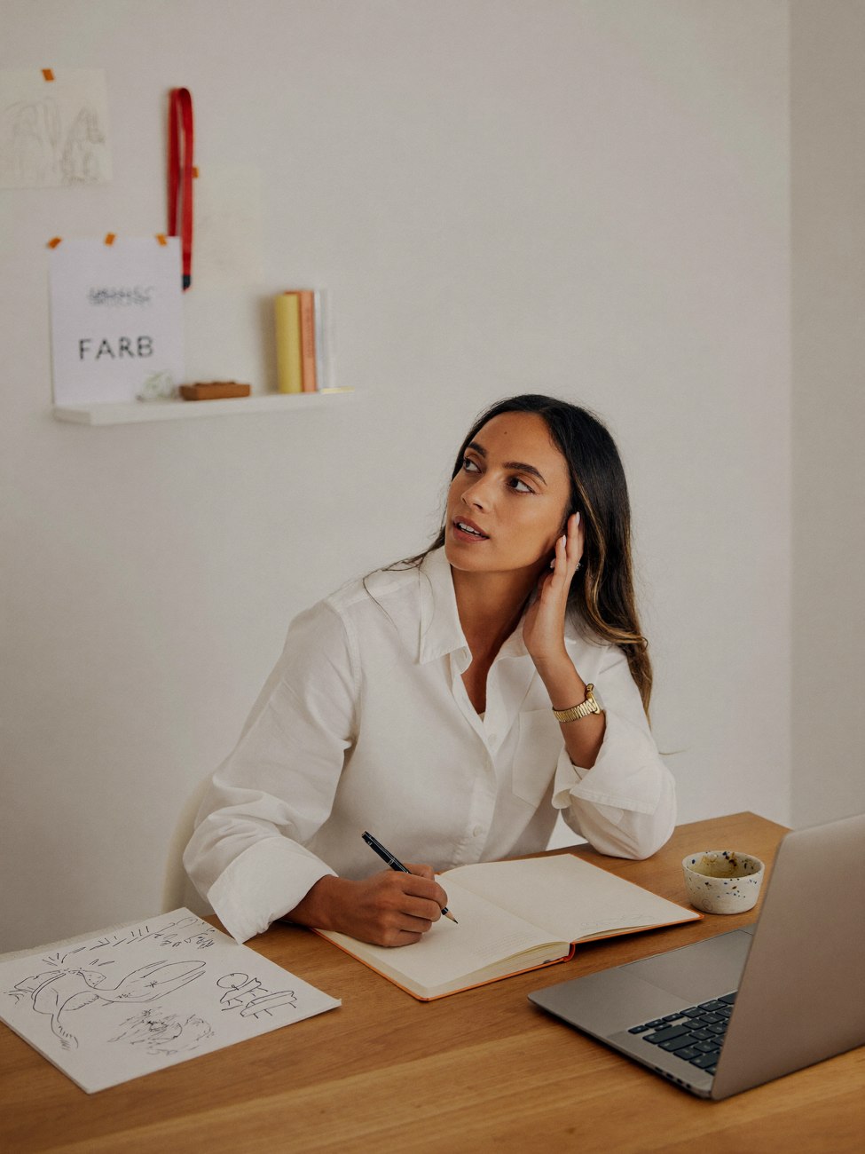 A person reflecting with a notebook in a sunlit room