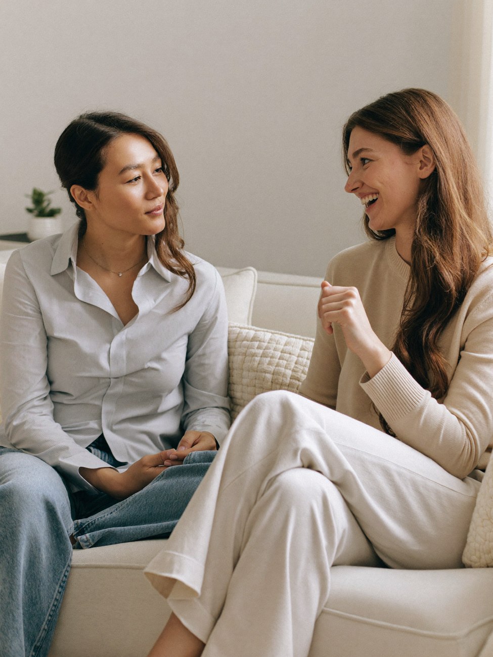 Two friends talking in a bright room